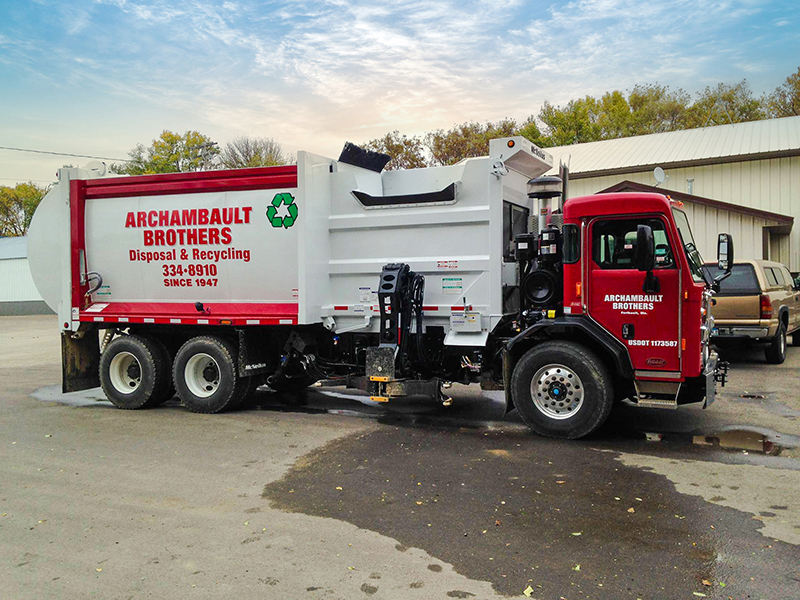 New residential garbage truck with picking arm used by Archambault Brothers Disposal